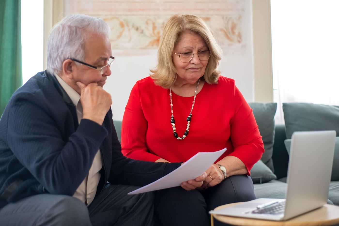 An older couple reviewing NHS Continuing Healthcare paperwork together at home