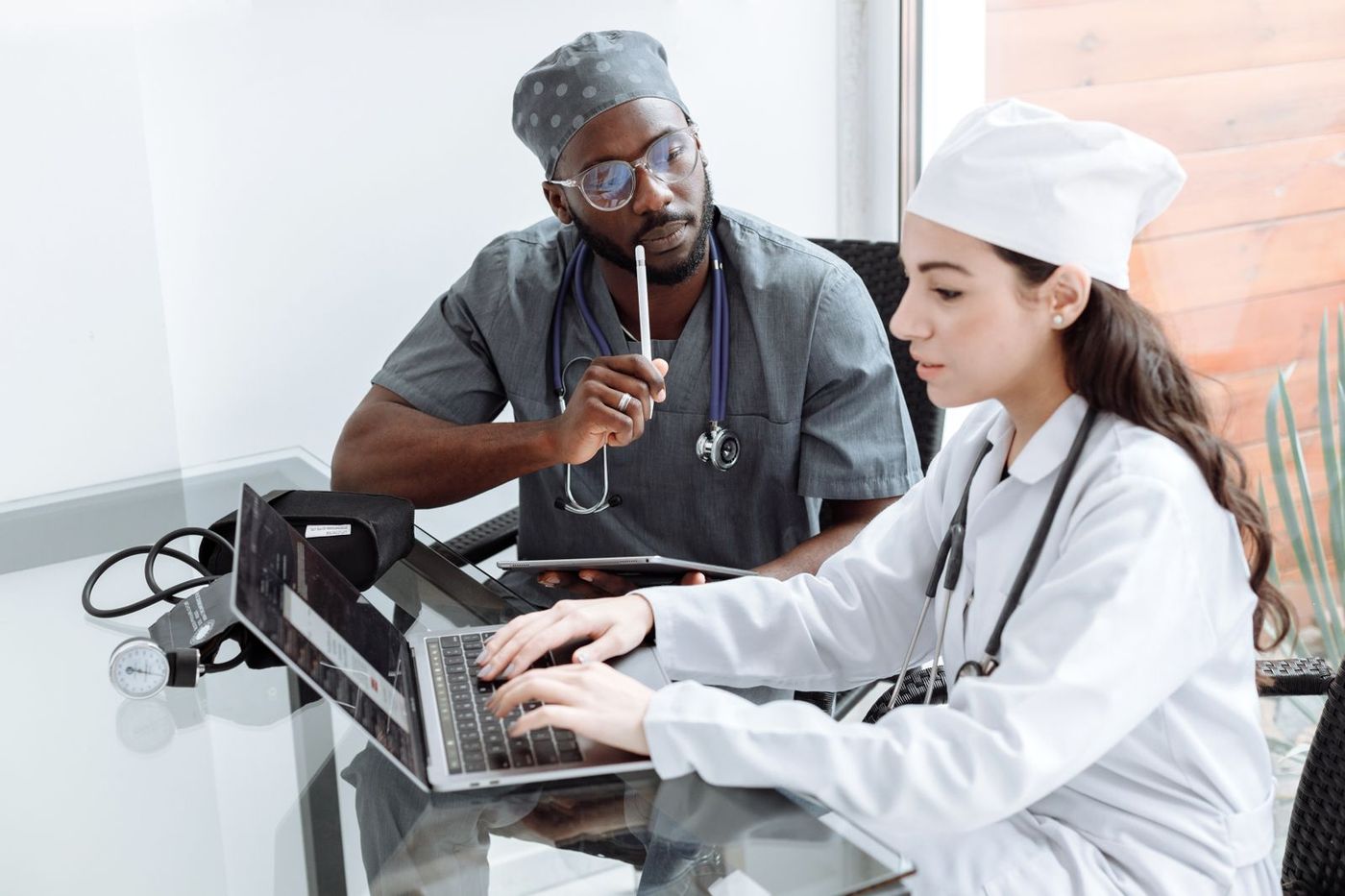 Two care managers reviewing staffing figures on a laptop together