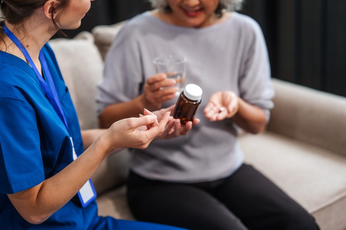 Healthcare professional assisting a client with medication